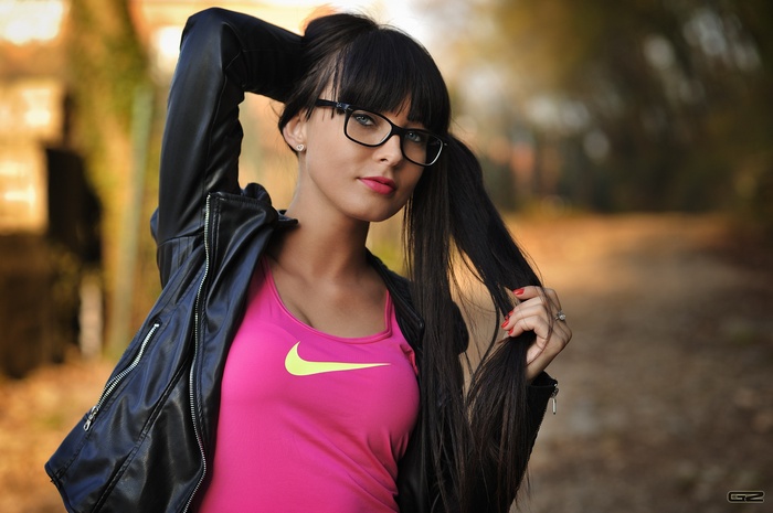 Woman with glasses and pigtails wearing Nike tank top