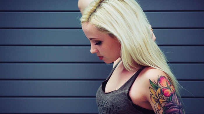 Woman with blonde hair and a floral tattoo