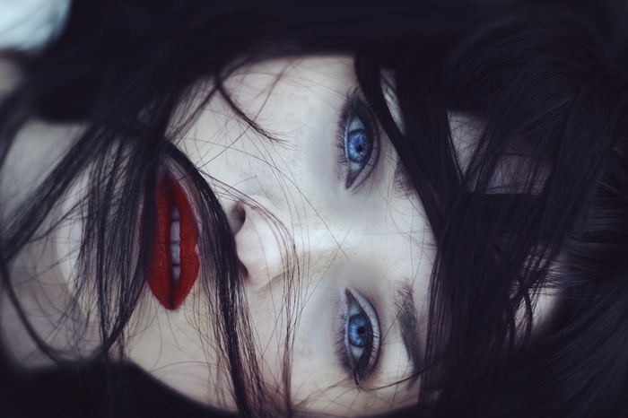 Woman with dark hair and blue eyes