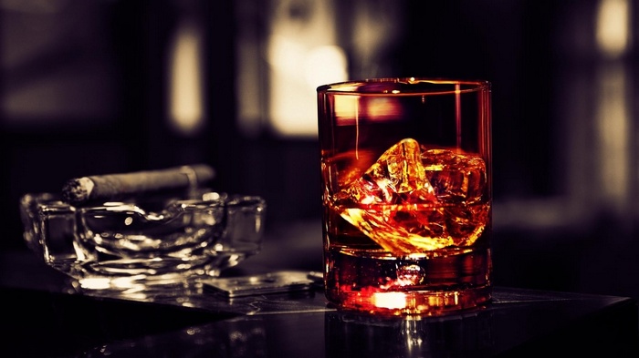 Whiskey and cigar on a bar