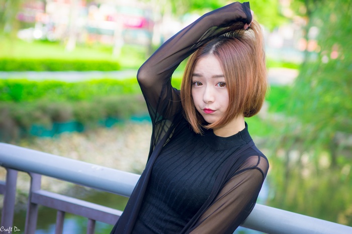 Asian woman with short brown hair posing