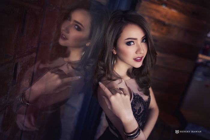 Asian model in black lace dress with reflection