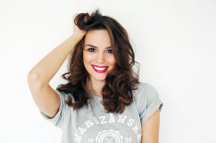 Paulina Krupińska smiling with hand in her wavy hair