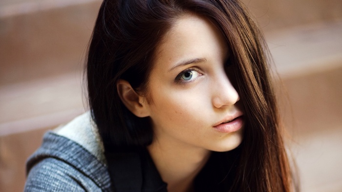 Emily Rudd with hair in face and sensual gaze