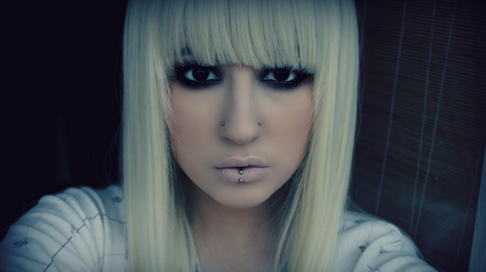 Woman with blonde hair and piercings