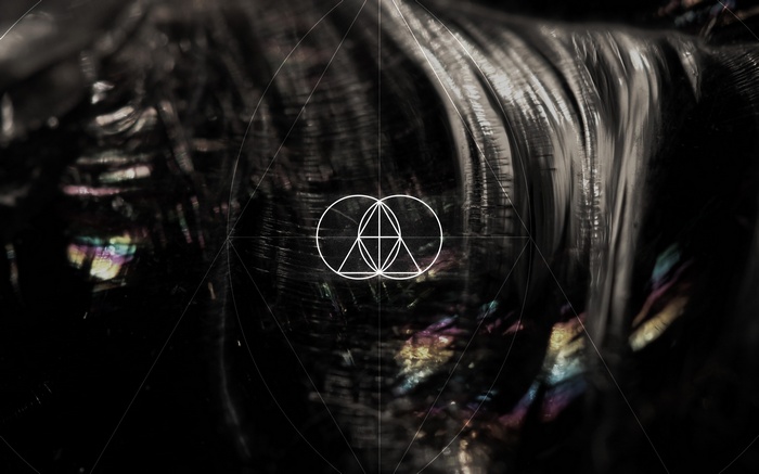 The Glitch Mob geometric symbol on dark background