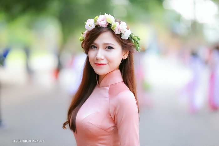 Asian woman wearing a pink dress and flower crown
