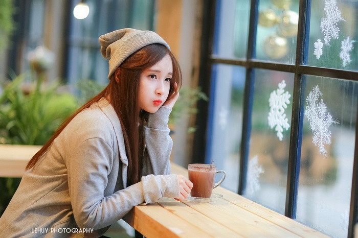 Asian woman in a cafe with hot chocolate