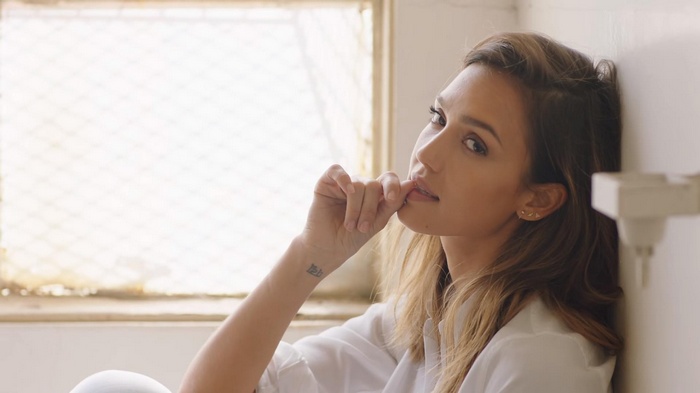 Jessica Alba leaning against a wall