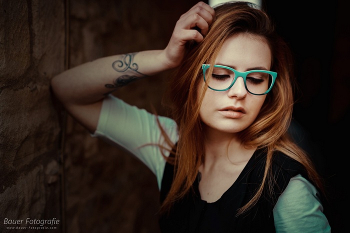 Woman with glasses and tattoo