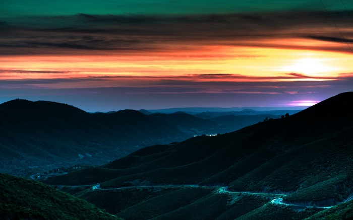 Road through mountains at sunset