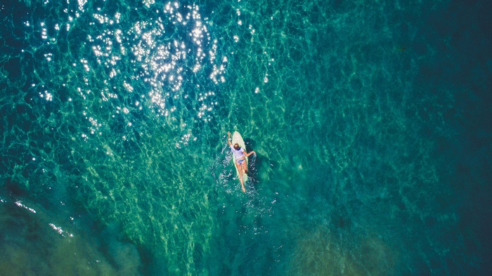 Woman surfing on a surfboard in the ocean