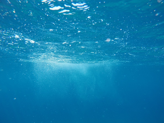Underwater view of the sea with sunlight and bubbles