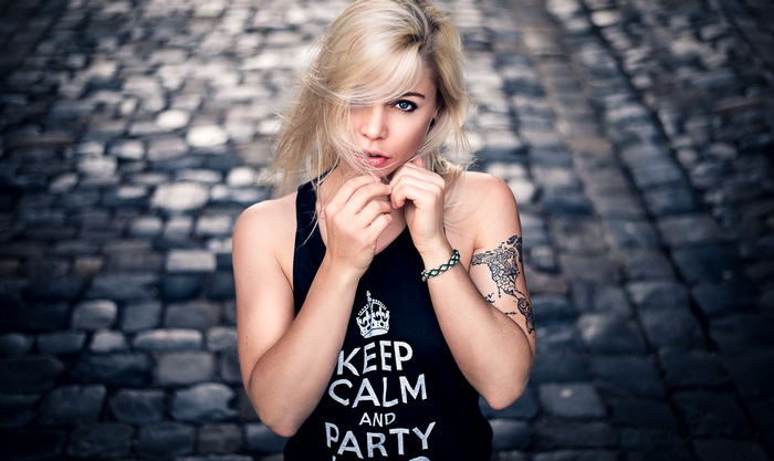 Woman with blonde hair and a tattoo
