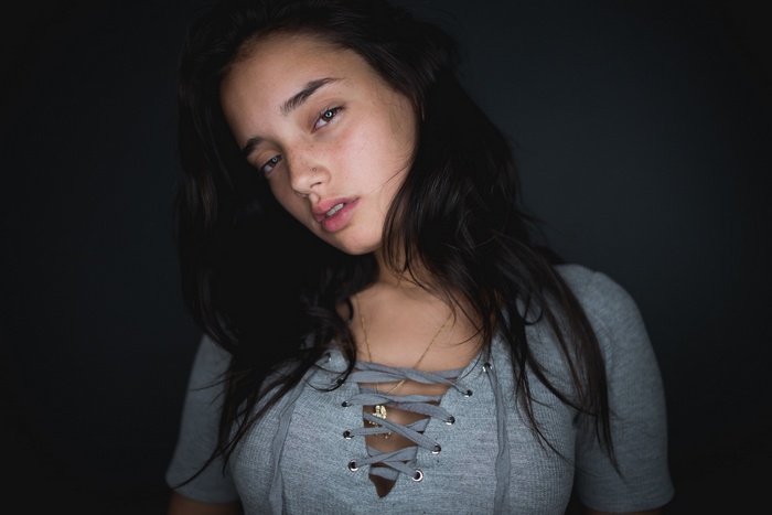 Woman with dark hair and freckles