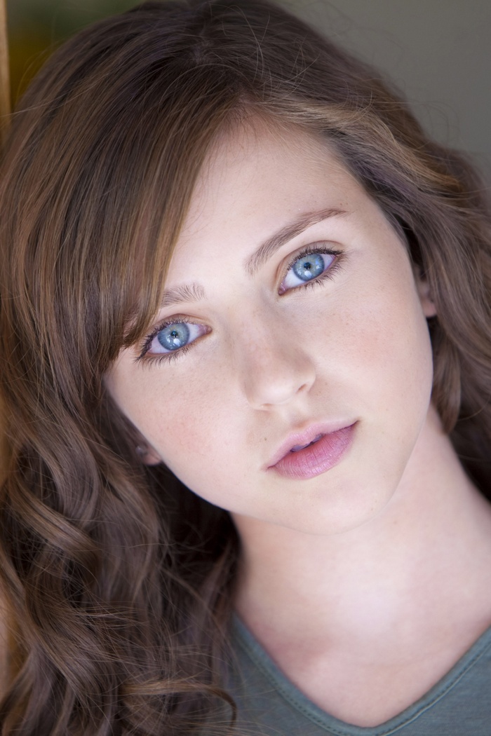 Close-up portrait of a young woman with blue eyes