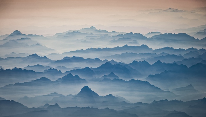 Misty mountain range at sunrise