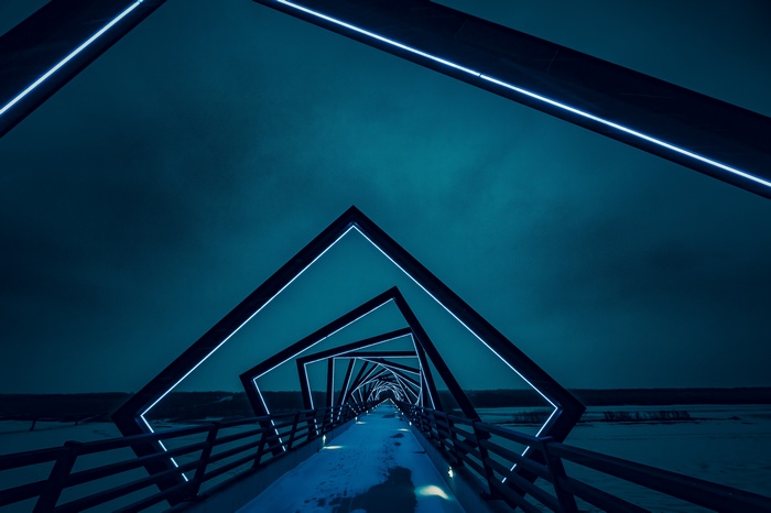 Geometric bridge with neon lights at night