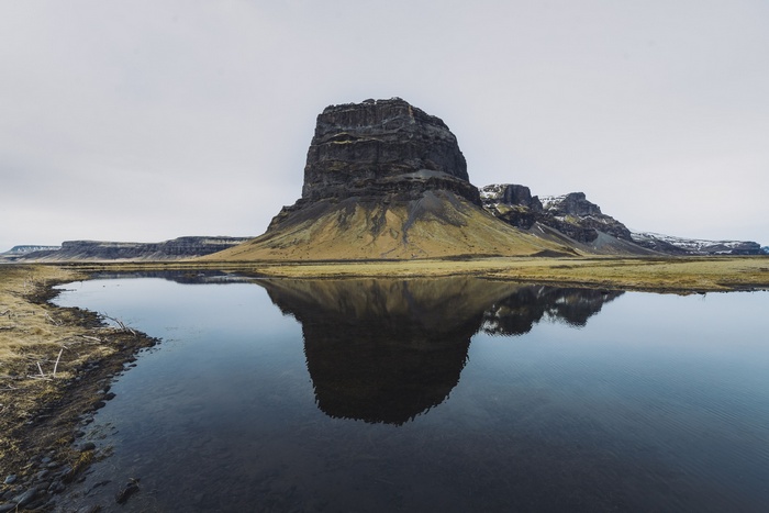 Flat-topped mountain reflected in water