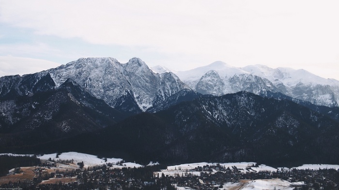 Snow-covered mountains above a village