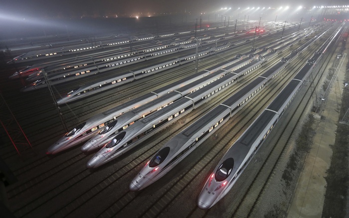 High-speed trains parked in a rail yard at night in China