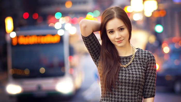 Woman in a patterned dress with a gold necklace