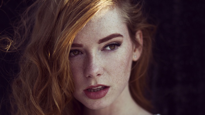 Redhead woman with freckles and lipstick