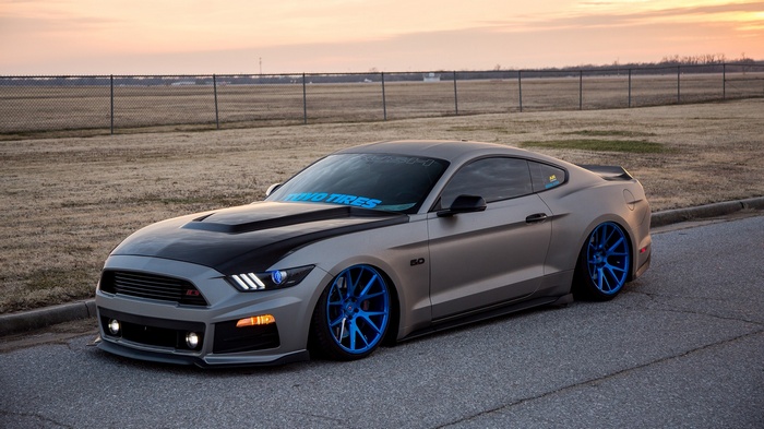 Matte gray Ford Mustang with blue rims