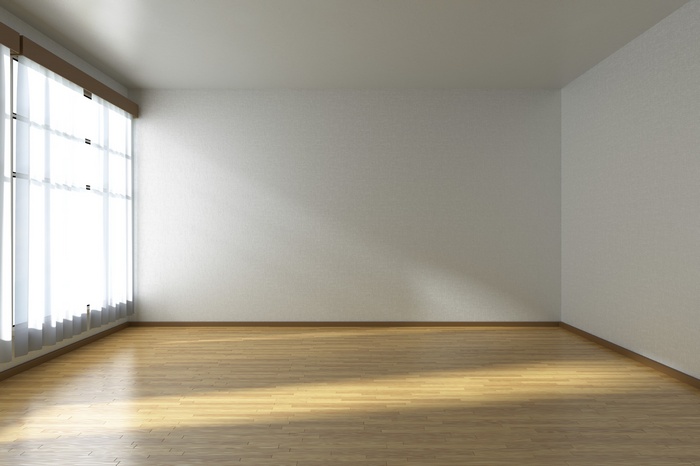 Empty room with large window and wooden floor