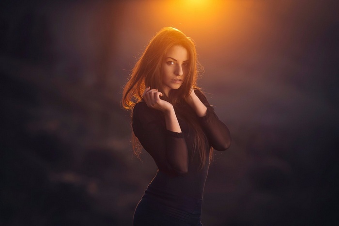 Woman in black dress with orange light