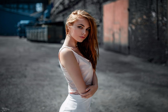 Woman with blonde hair in a tank top and skirt