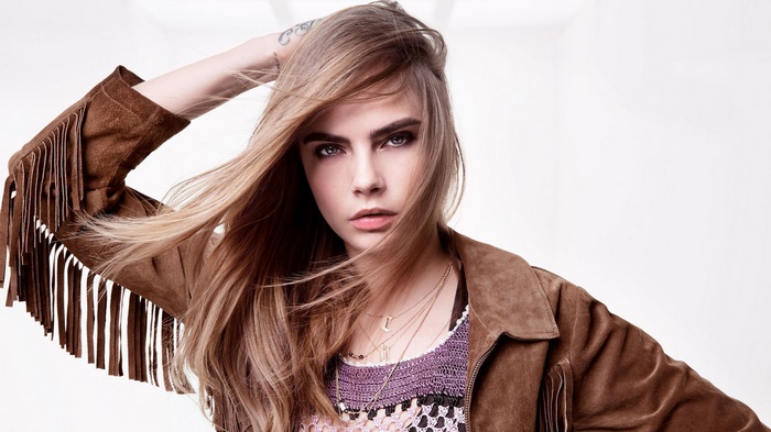 Cara Delevingne in a brown fringed jacket