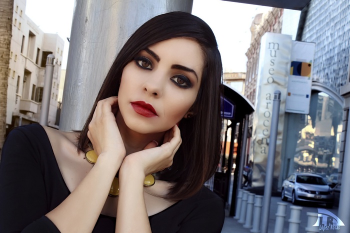 Woman with red lipstick and dark makeup