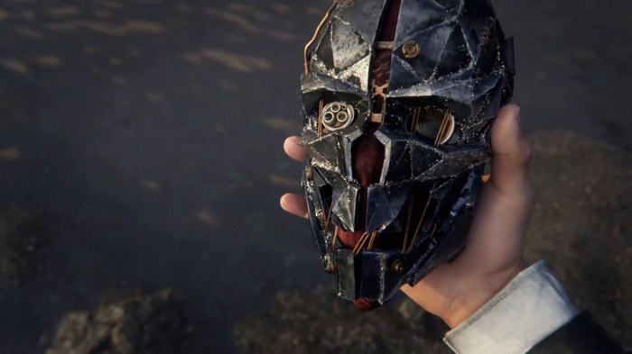 Corvo Attano holds a mask from Dishonored 2
