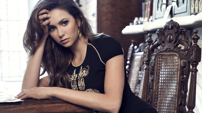 Nina Dobrev in a black dress with gold embroidery
