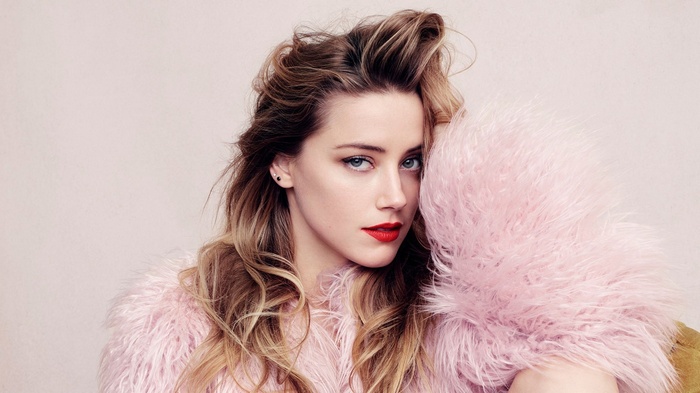 Amber Heard with long wavy hair and pink fur