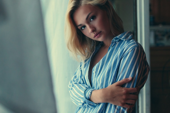 Portrait of a blonde woman in a striped shirt