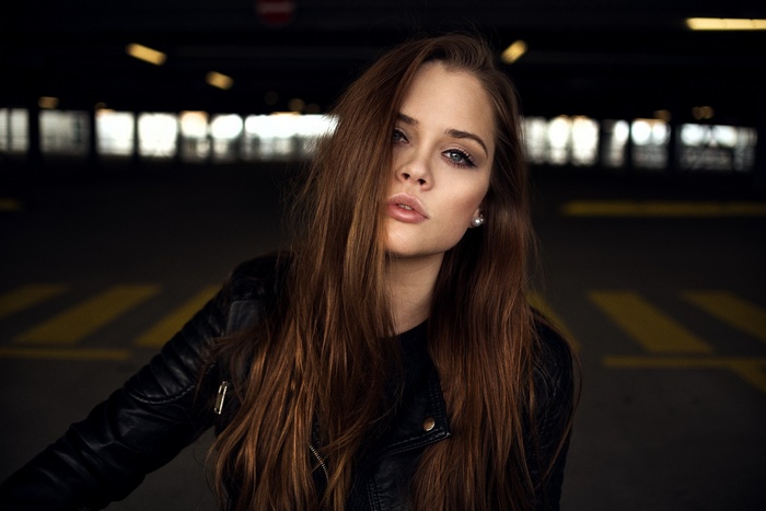 Woman with long brown hair wearing a black jacket