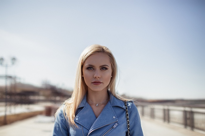 Blonde woman in a blue jacket outdoors