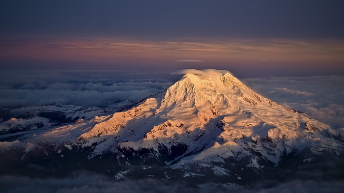 Mount Rainier covered in snow at sunrise