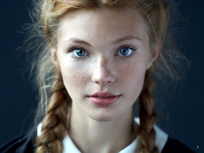 Dasha Milko with blue eyes and freckles in braids