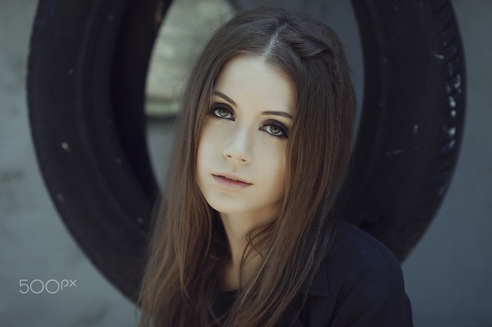 Ksenia Kokoreva posing in front of a tire