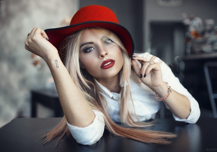 Woman with red hat and tattoo by Alessandro Di Cicco