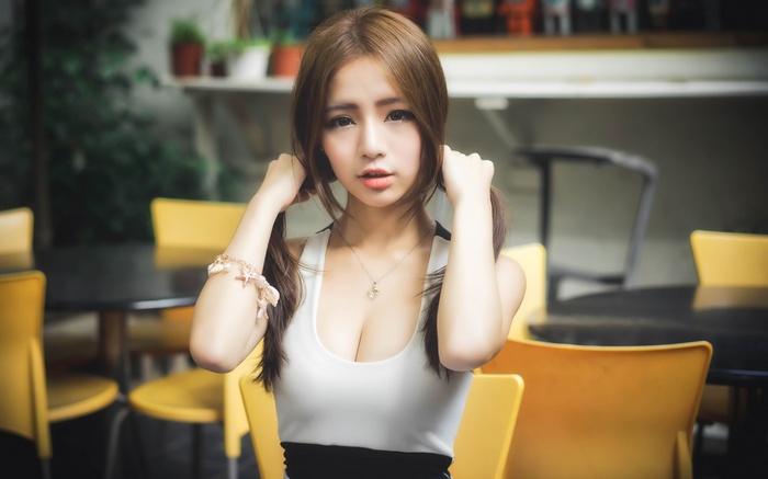 Asian woman with auburn hair wearing a dress