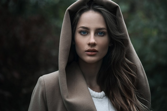 Woman with blue eyes wearing a hood
