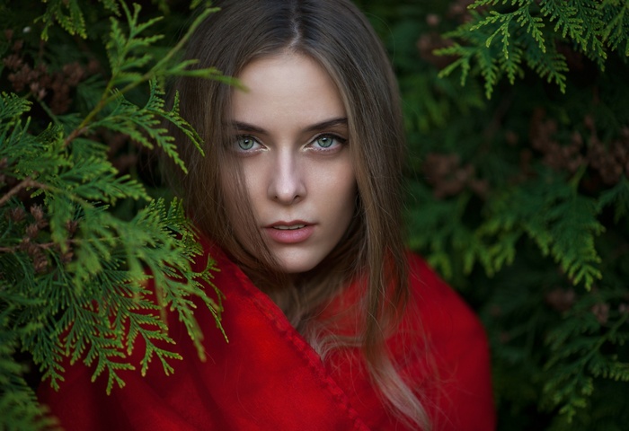 Amina Katinova portrait with red scarf and green foliage