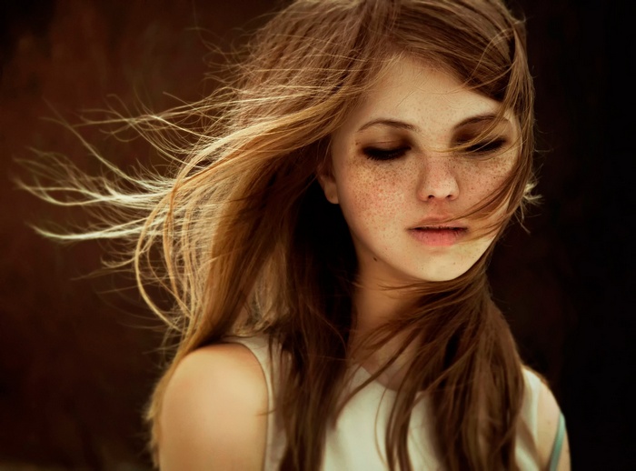 Woman with freckles and windblown hair