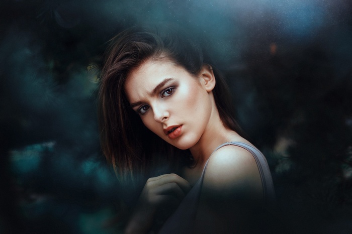 Woman with dark hair looking at the viewer