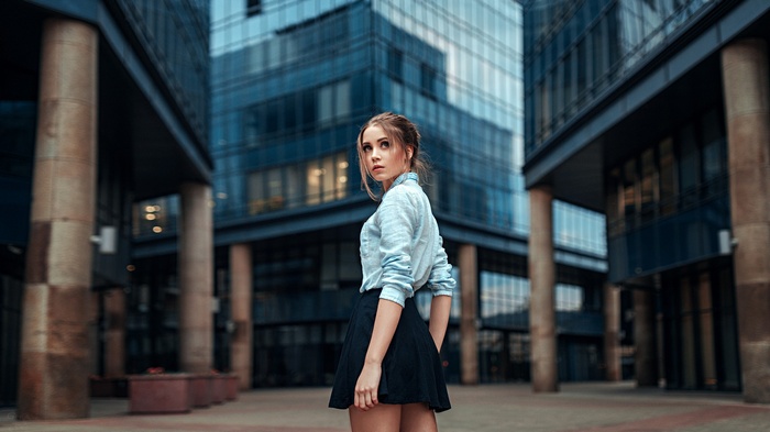 Ksenia Kokoreva in a black skirt and shirt outdoors
