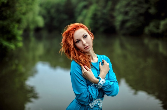 Anna Boevaya in a blue dress by the river